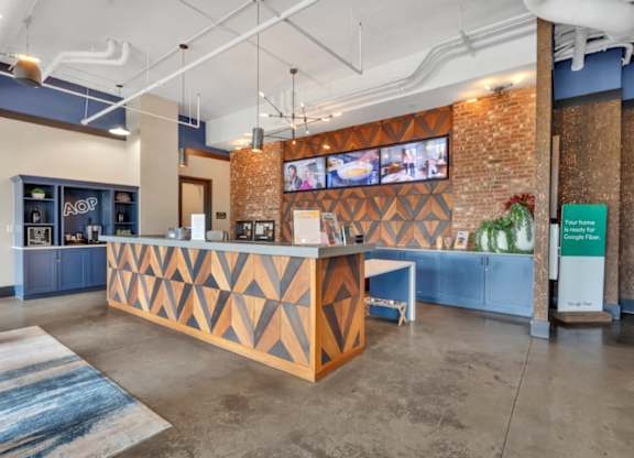 A reception area with a wooden counter and a TV mounted on the wall.