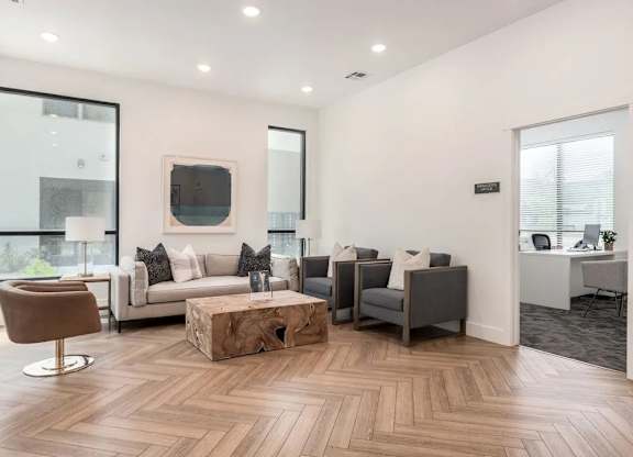 A living room with a brown chair and a white couch.