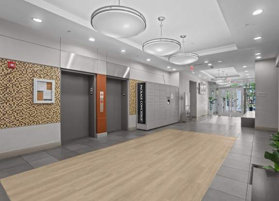 A hallway with a wooden floor and a patterned wallpapered wall.