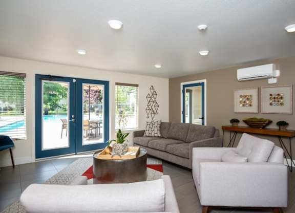 A living room with a white sofa, a grey couch, and a coffee table.