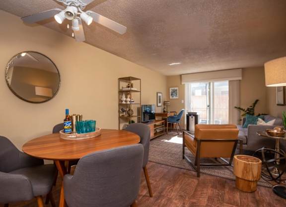 A living room with a dining table and chairs.