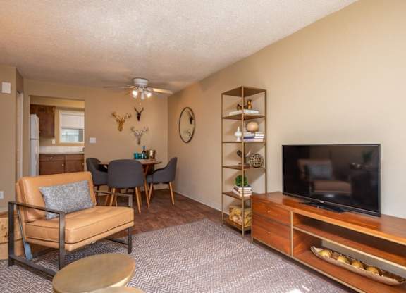A living room with a brown chair and a brown table.