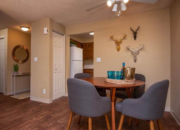 A dining room with a table and chairs.