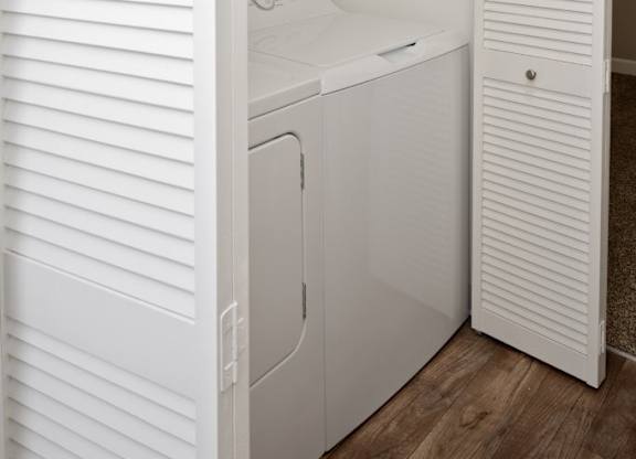 A white washing machine and dryer in a small laundry room.