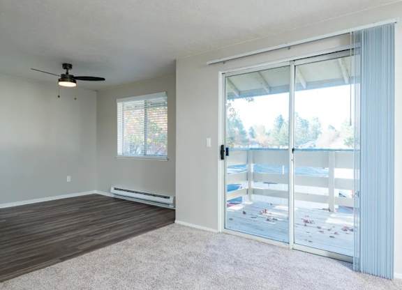 A room with a sliding glass door leading to a balcony.
