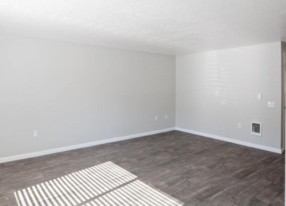A room with a striped rug on the floor.