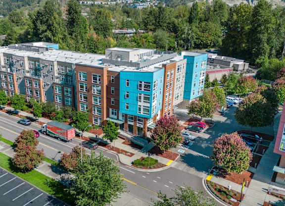 A parking lot in front of a multi-story building.