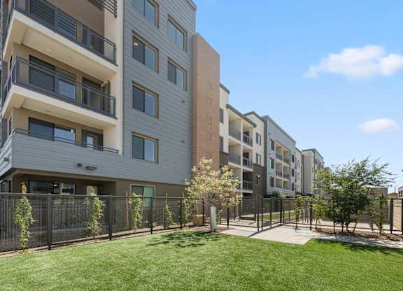 Apartment complex with a green lawn in front.