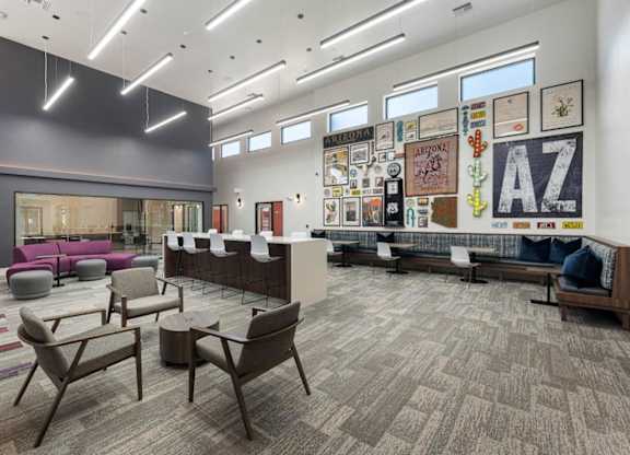 A large room with a carpeted floor and a long couch and chairs