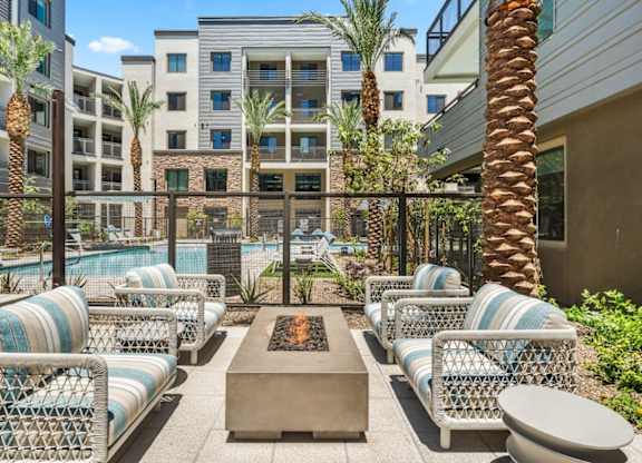 A fire pit with lounge chairs