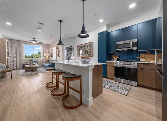 A modern kitchen with a bar area and a dining area.