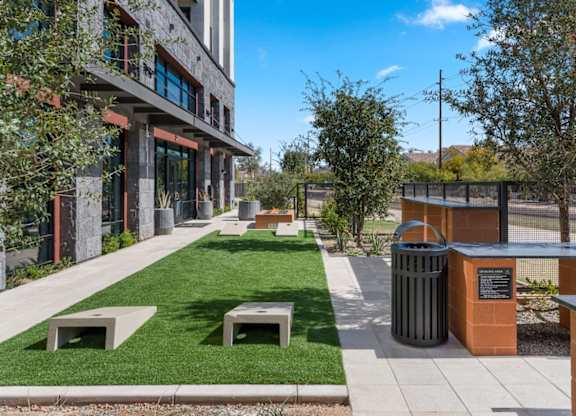 A modern building with a green lawn in front.