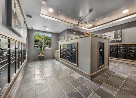 A room with a grey floor and black cabinets.