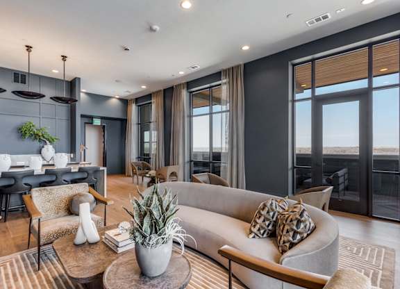 A modern living room with a grey sofa and a wooden coffee table.