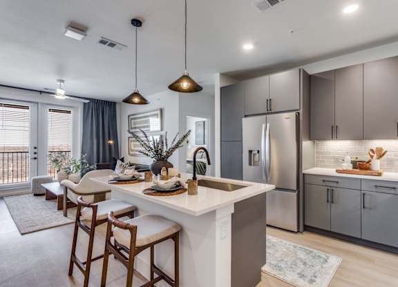 A modern kitchen with a dining area and a balcony.