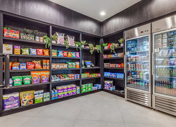 A frozen food section in a store with shelves stocked with frozen foods and a refrigerated display case.