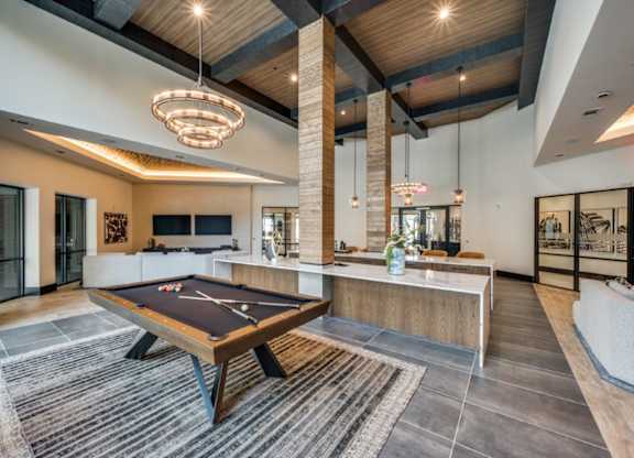 A room with a pool table and a couch.