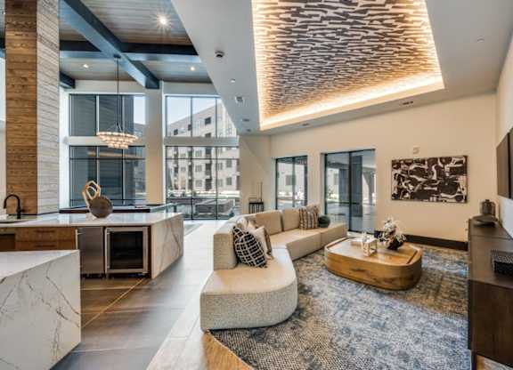 A modern living room with a large window and a wooden floor.