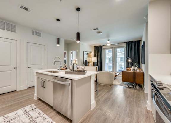 A modern kitchen with a large island and a dining area.