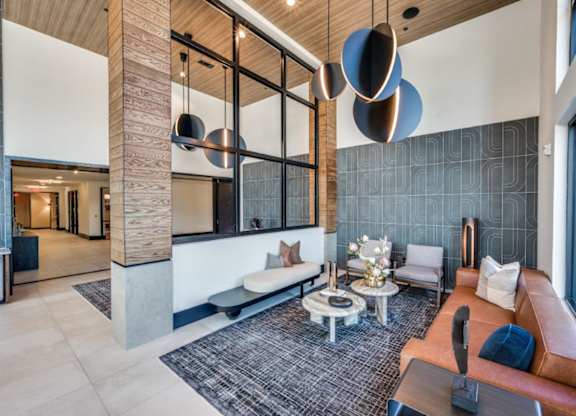 A modern living room with a brown leather couch and a coffee table.