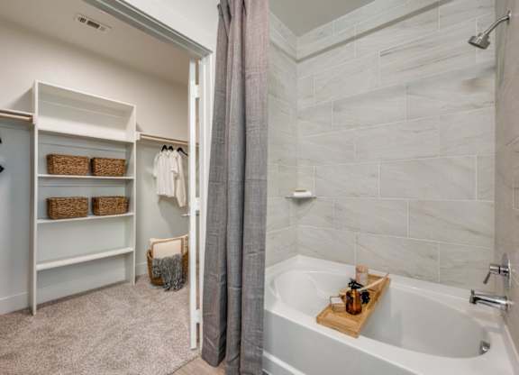 A bathroom with a tub and a walk-in shower.