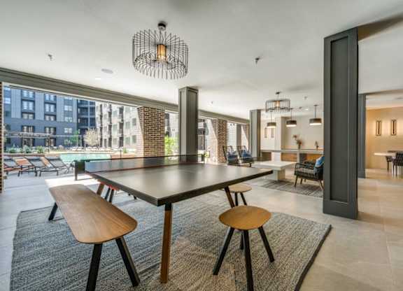 A modern dining room with a large table and chairs.