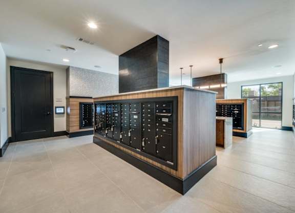 A modern lobby with a black and wood reception desk.