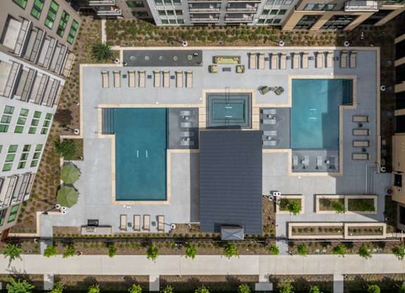 A modern building with a pool and a green roof.