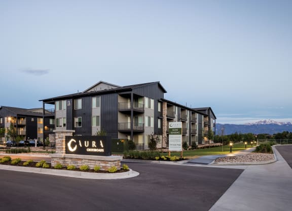 a large apartment building with a sign in front of it