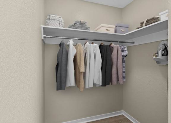 Clothes hanging on a rack in a room.