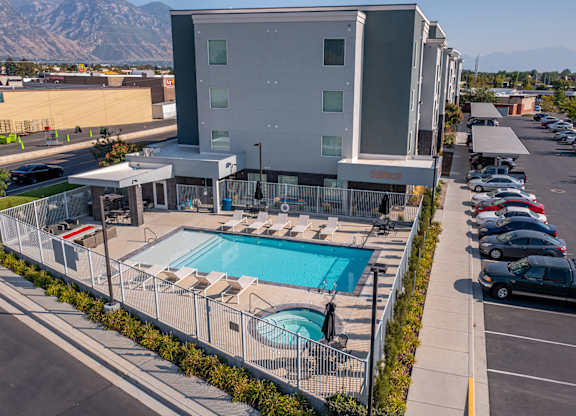 A modern building with a pool in front.
