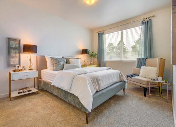 a bedroom with a bed and a chair