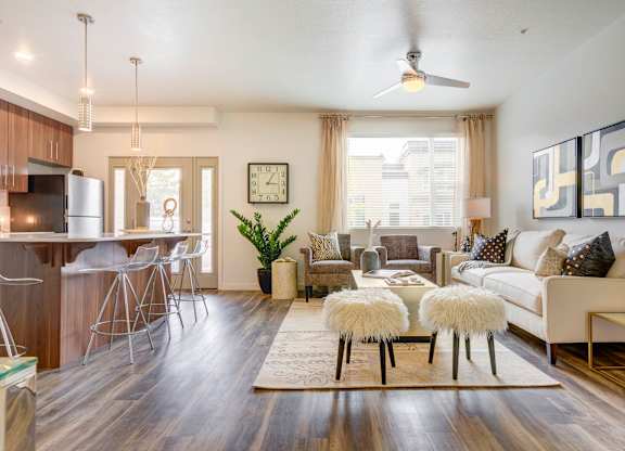 a living room with hardwood flooring and a ceiling fan