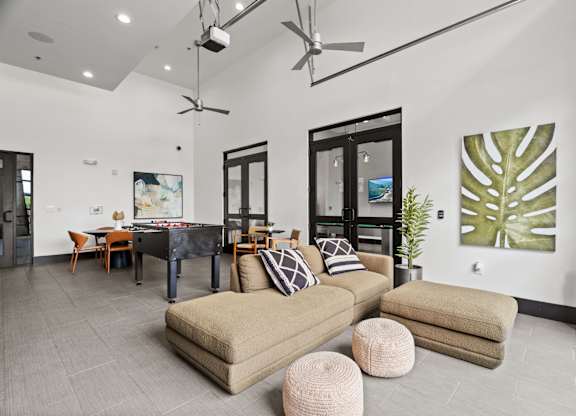 A living room with a pool table and a couch.
