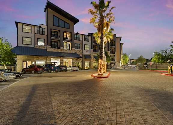 A large building with a parking lot in front of it.