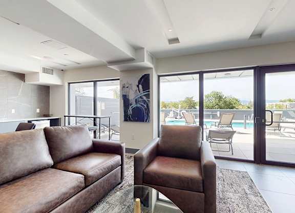 A living room with a brown couch and a chair.