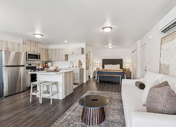 A modern kitchen with a white couch and a coffee table.