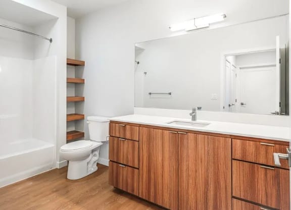 A white toilet sits next to a sink in a bathroom.