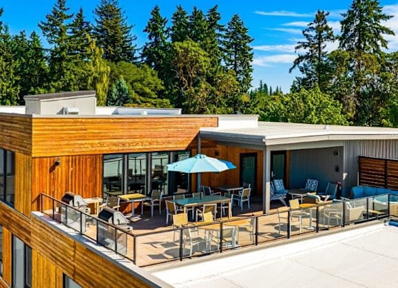 A modern house with a wooden exterior and a spacious deck.