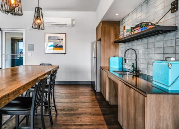 A kitchen with a wooden table and chairs.