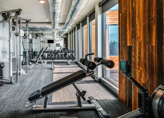 A gym with a variety of equipment including a leg press machine.