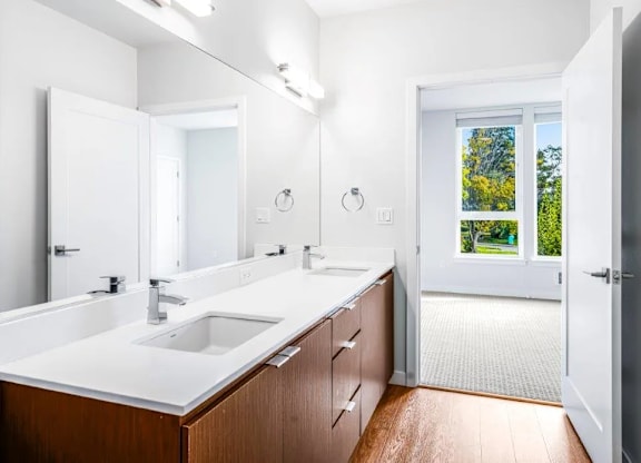 A bathroom with a white sink and a mirror.