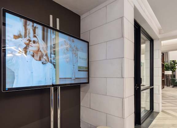 A modern living room with a flat screen TV mounted on the wall.