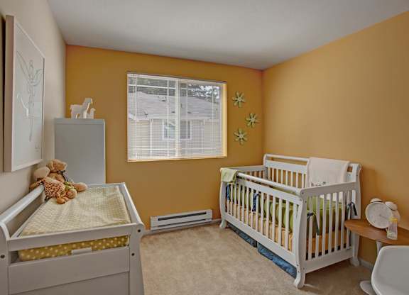 A baby room with a crib and a changing table.