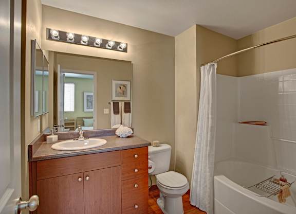 A bathroom with a sink, toilet, and bathtub.