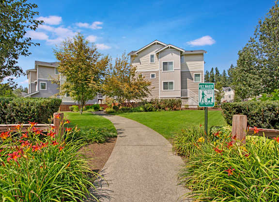 A residential area with apartment buildings and a walking path.