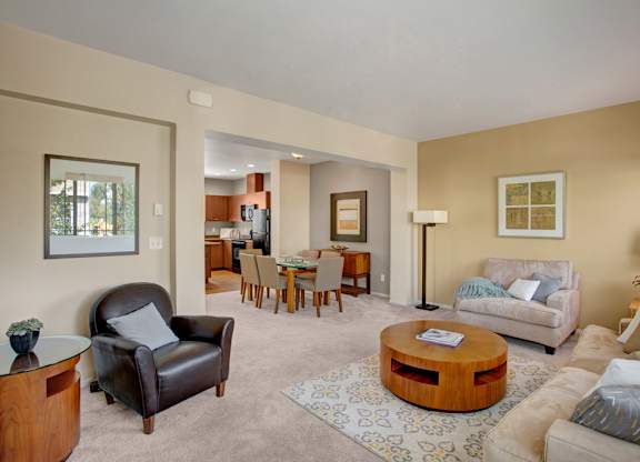 A living room with a brown leather chair and a wooden coffee table.