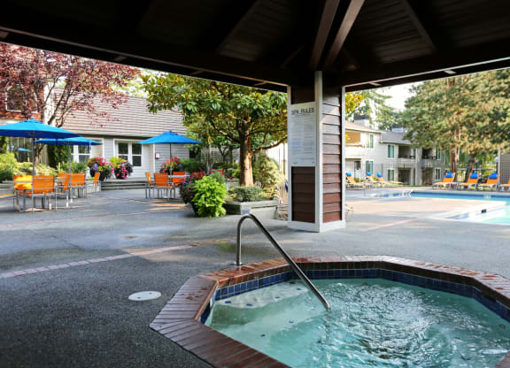 a jacuzzi and pool at the resort on a sunny day