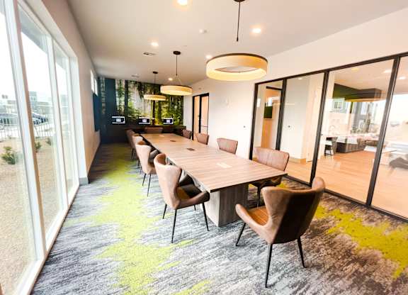 A conference room with a long table and chairs.