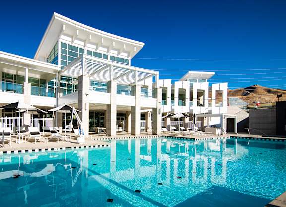 A large swimming pool in front of a modern building.